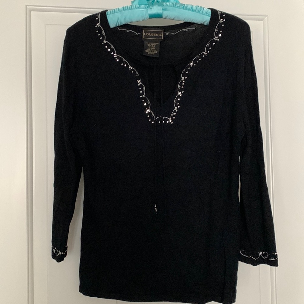Fine knit sweater with sequin detailing around the neck and sleeves